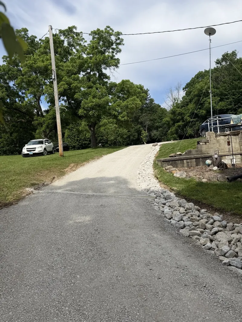 Gravel road with rip-rap edge installation